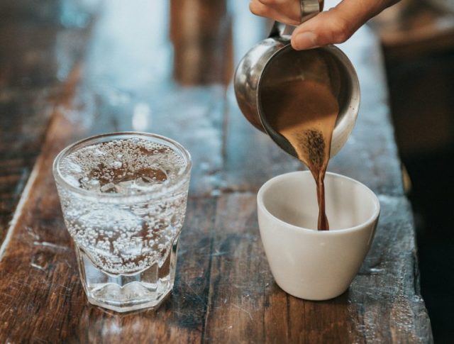 Het scheutje water dat bij de koffie wordt geserveerd, waarvoor dient het en wanneer moet het worden gedronken?
